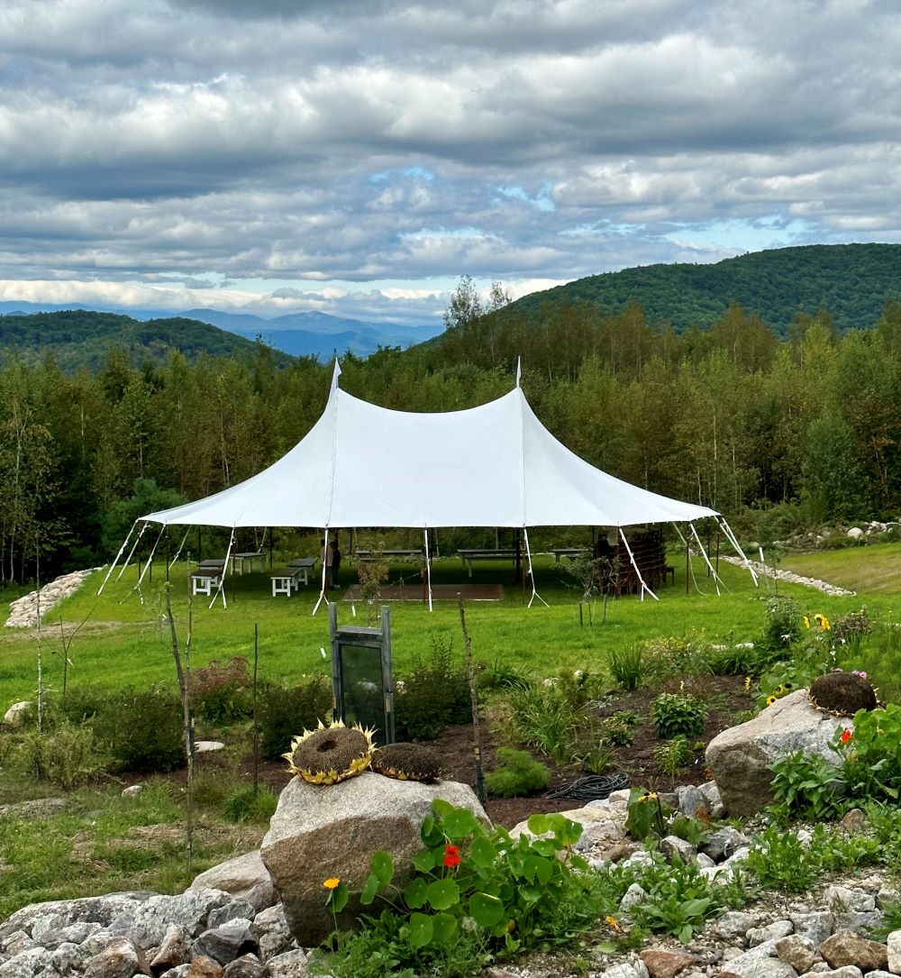 White tent in front of the small garden